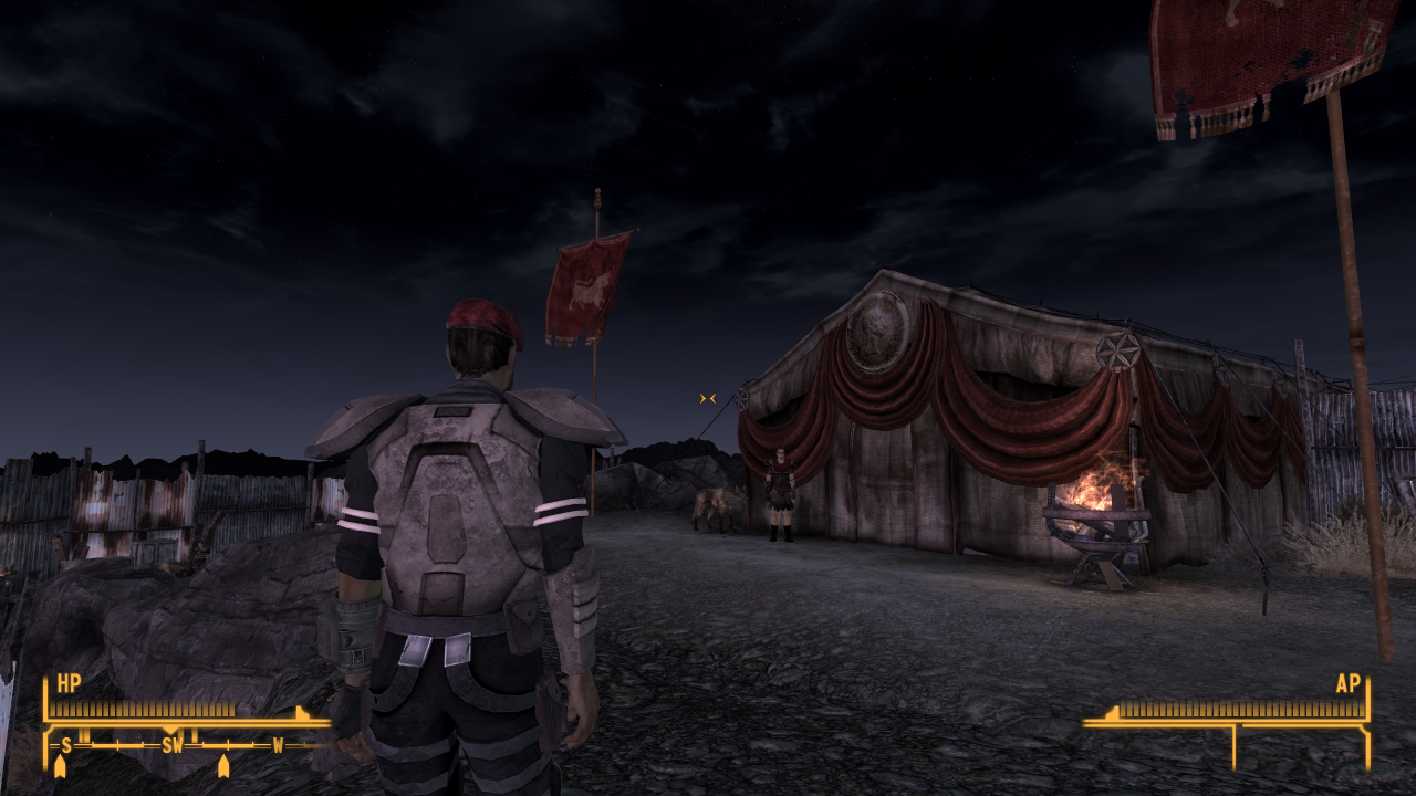 Screenshot from Fallout: New Vegas of a player in modern combat armour with a red beret standing outside a square tent with large square bull-motif banners and a classicising portrait of Caesar.